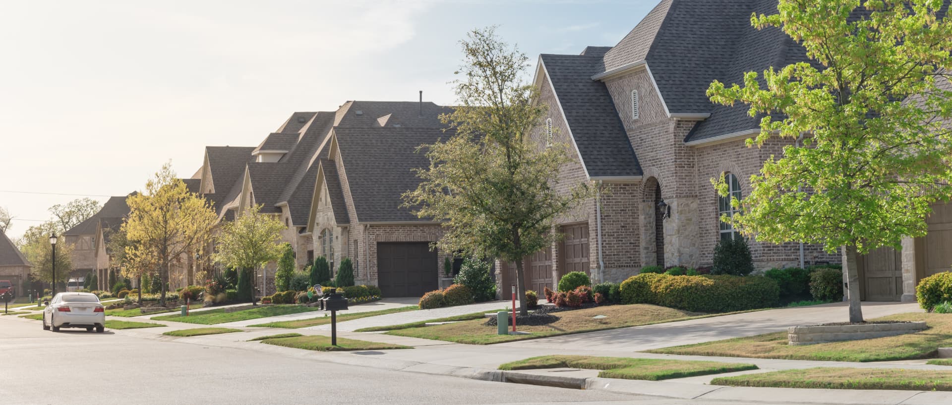 Brick homes along a sunlit residential street