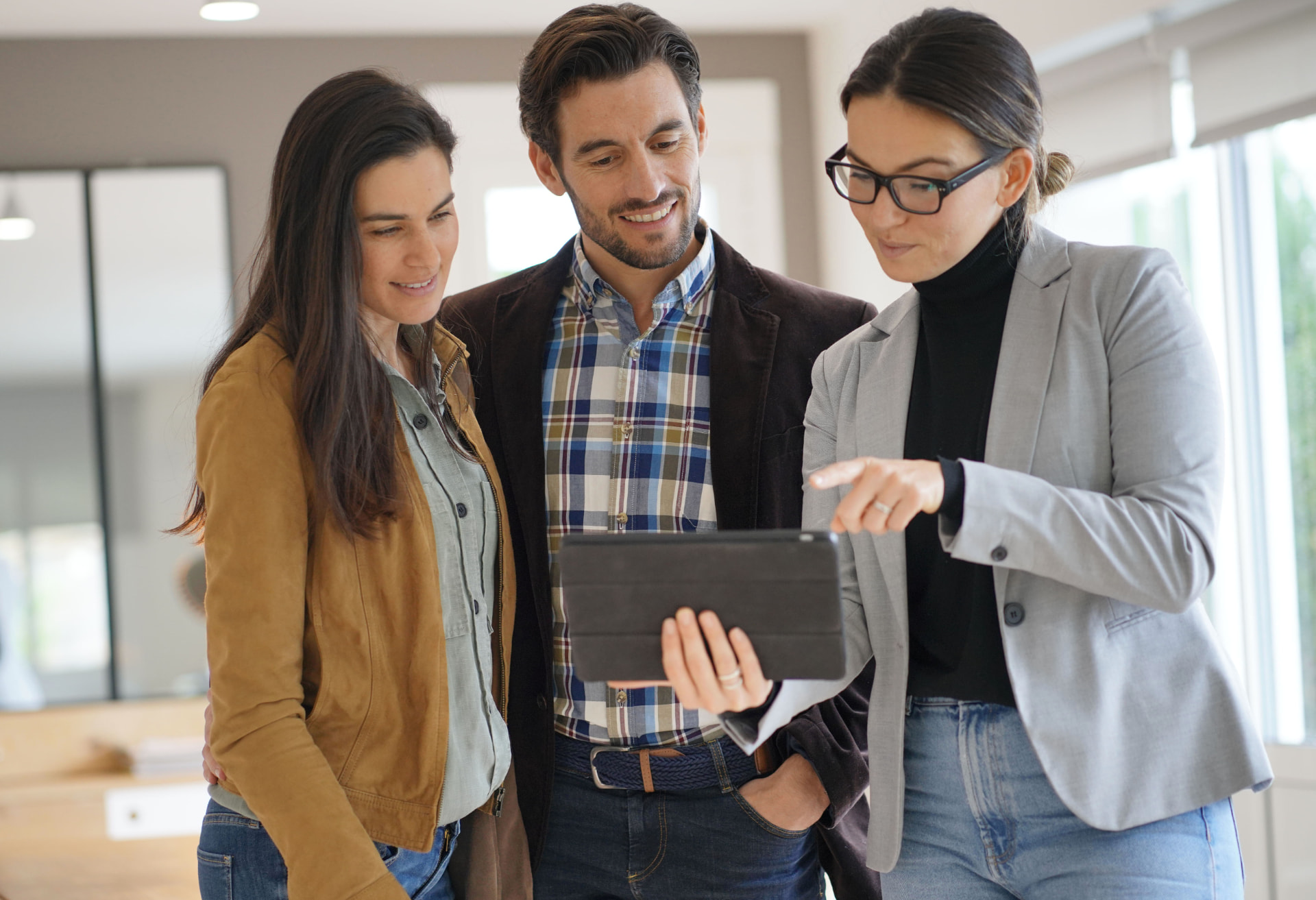 Property professionals reviewing roof photos on a tablet