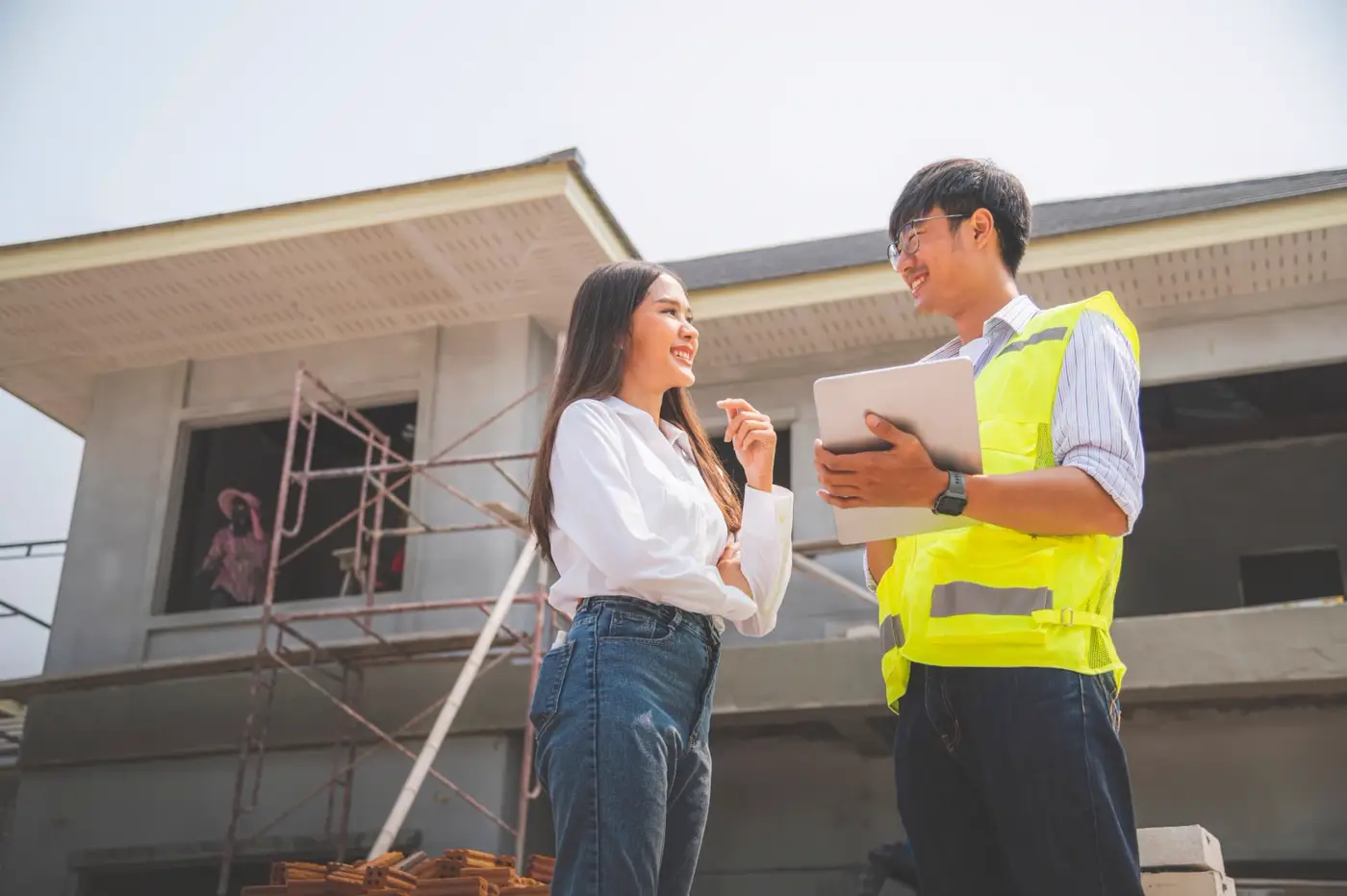 Real estate professional reviewing roof inspection findings with a certified inspector on site