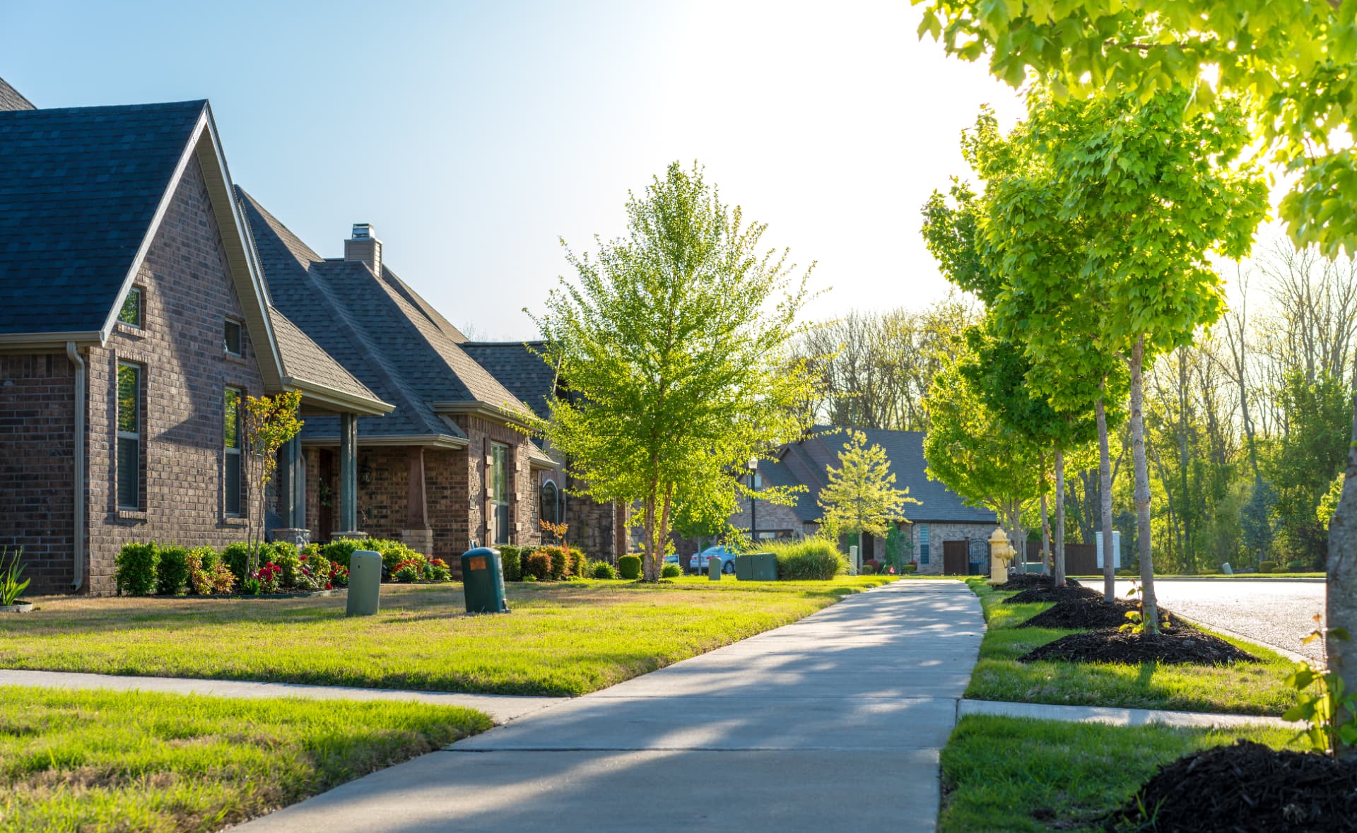 Brick homes along a sunlit residential street