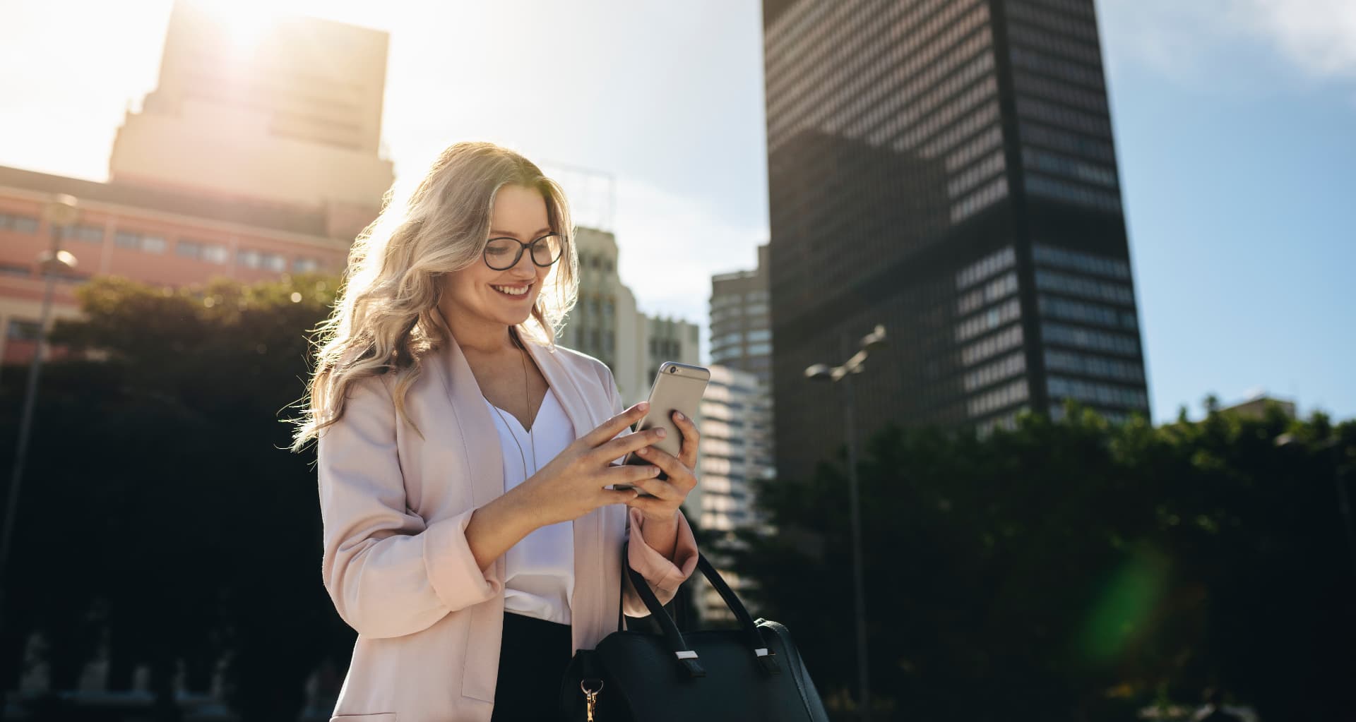 Property professional reviewing roof information on a smartphone outdoors