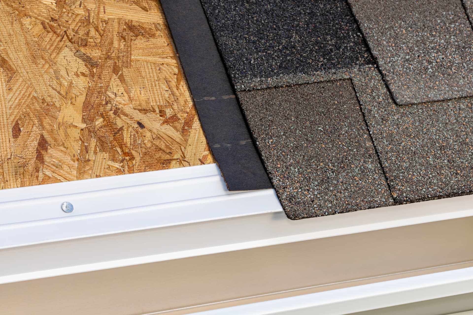 Close view of shingles, underlayment, and gutter edge