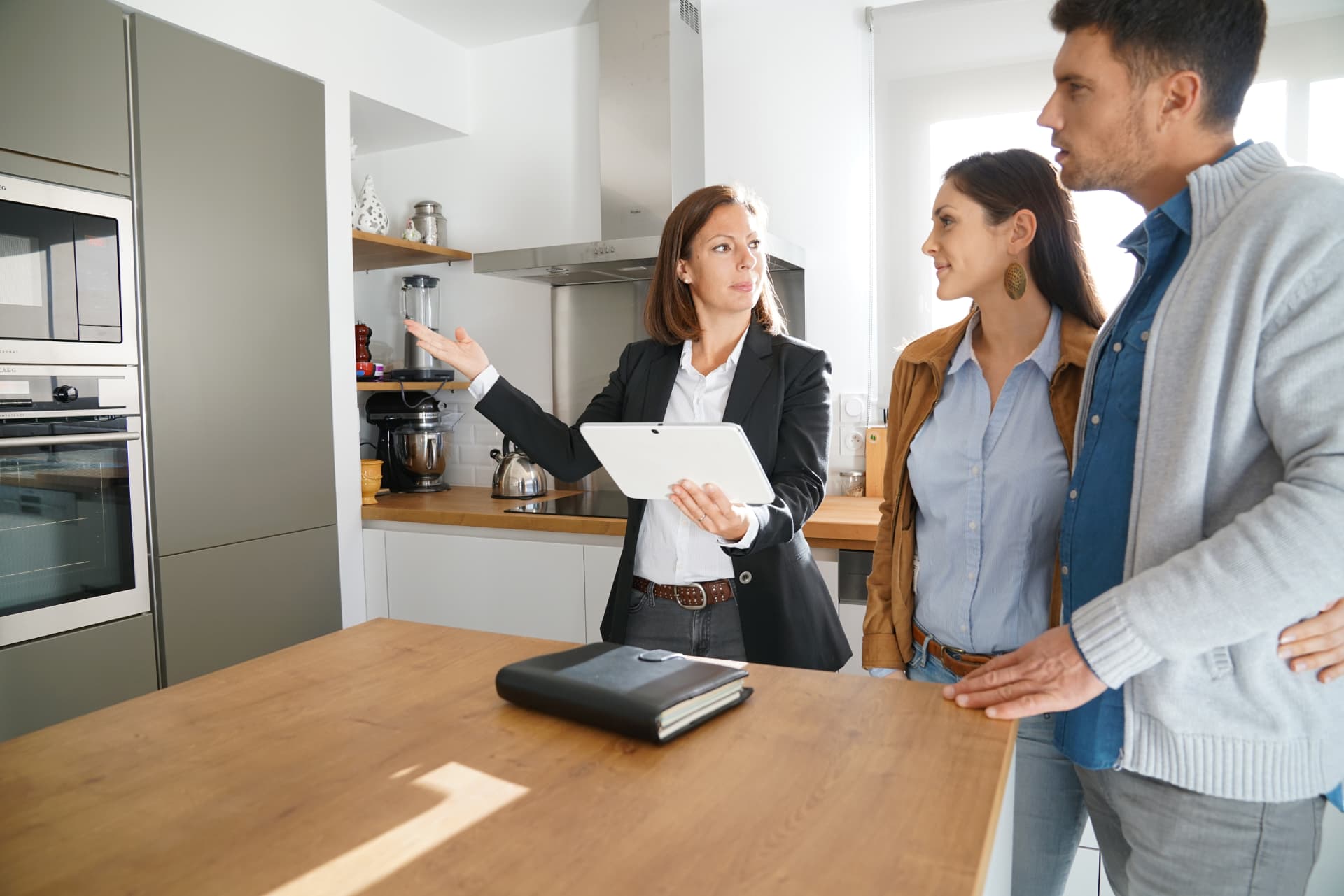 Agent reviewing property details with a couple